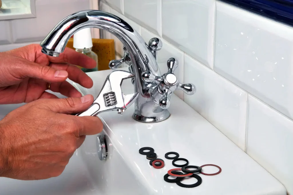 Plumber performing maintenance on a bathroom faucet in Hemet