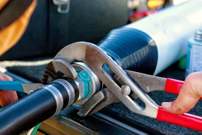 Technician tightening an industrial pipe connection in Hemet
