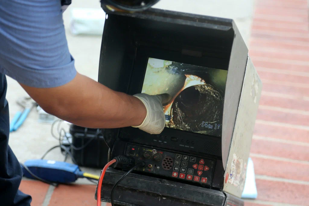 Technician viewing a drain inspection camera in Hemet