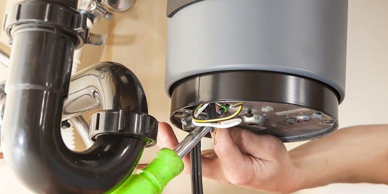 Technician repairing the heating element of a water heater in Hemet