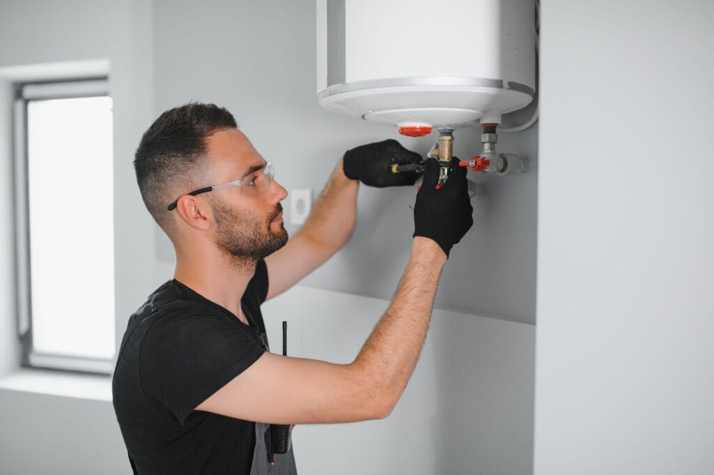 Technician performing water heater maintenance in Hemet